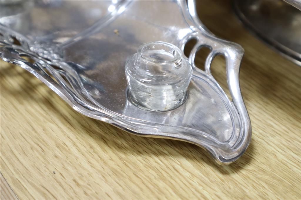 A WMF inkstand, 26cm wide, WMF plaque embossed with a young girl, and three Art Nouveau silver plated serving dishes (5)